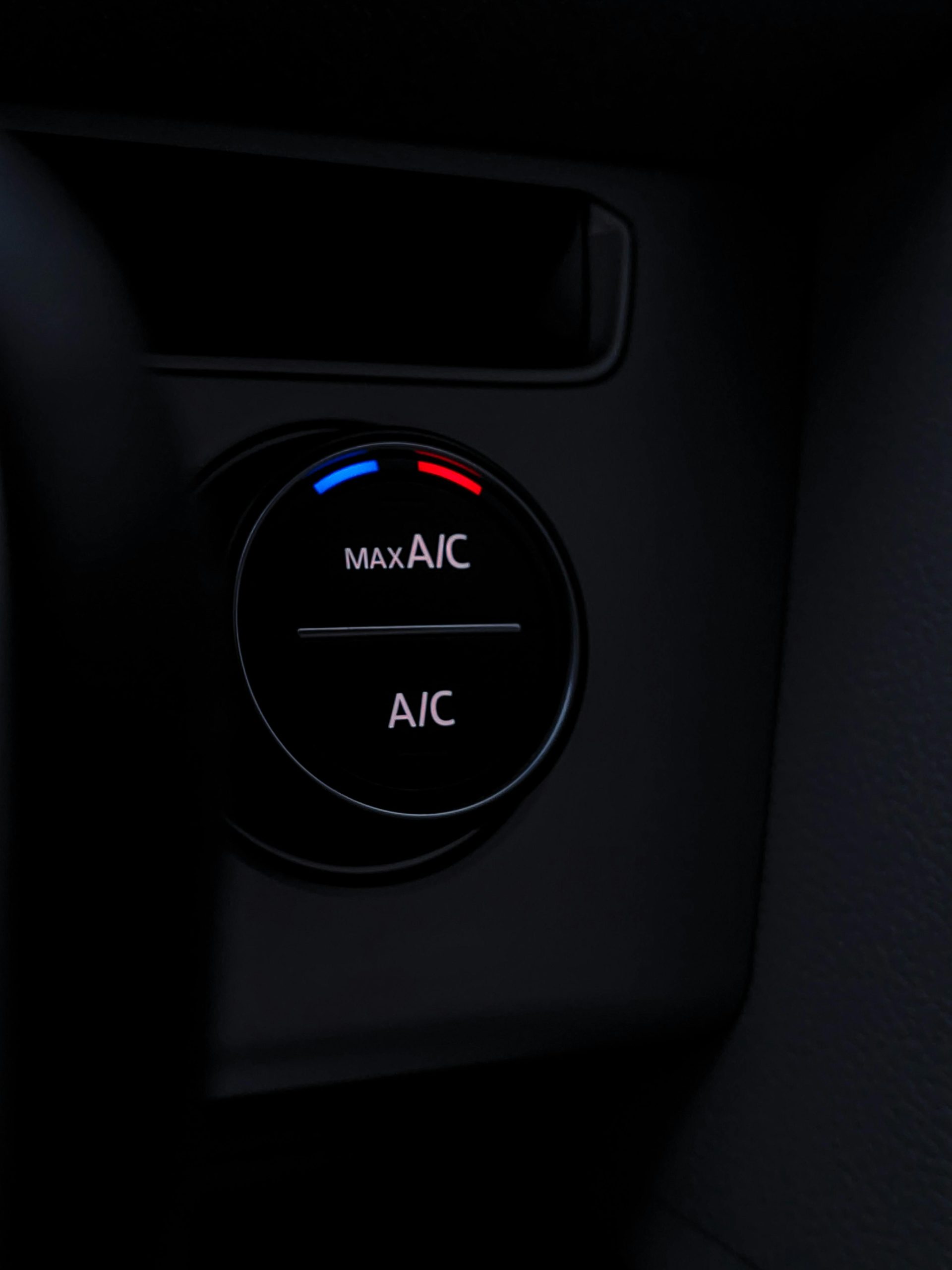 Services Detailed view of a car air conditioning control knob, highlighting its modern design and functionality.